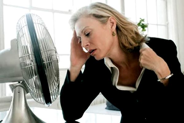 женщина сидит у вентилятора